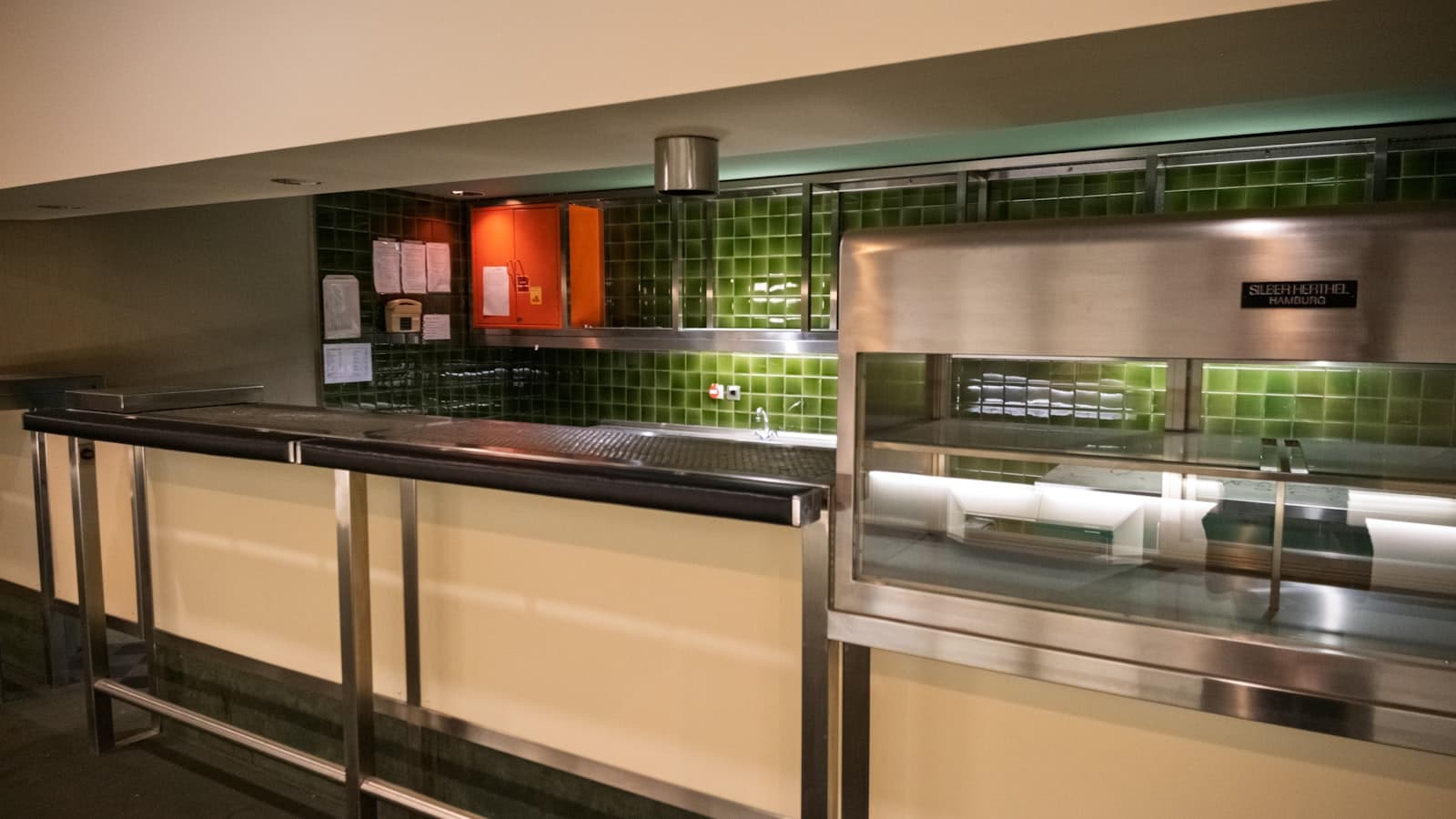 A clean professional kitchen with a steel work counter and equipment