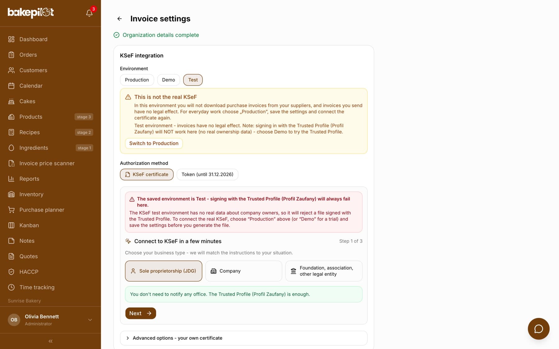 Invoice settings, KSeF integration section: the Test environment selected, a yellow This is not the real KSeF box with a Switch to Production button, the KSeF certificate authorization method and the first step of the Connect to KSeF in a few minutes wizard